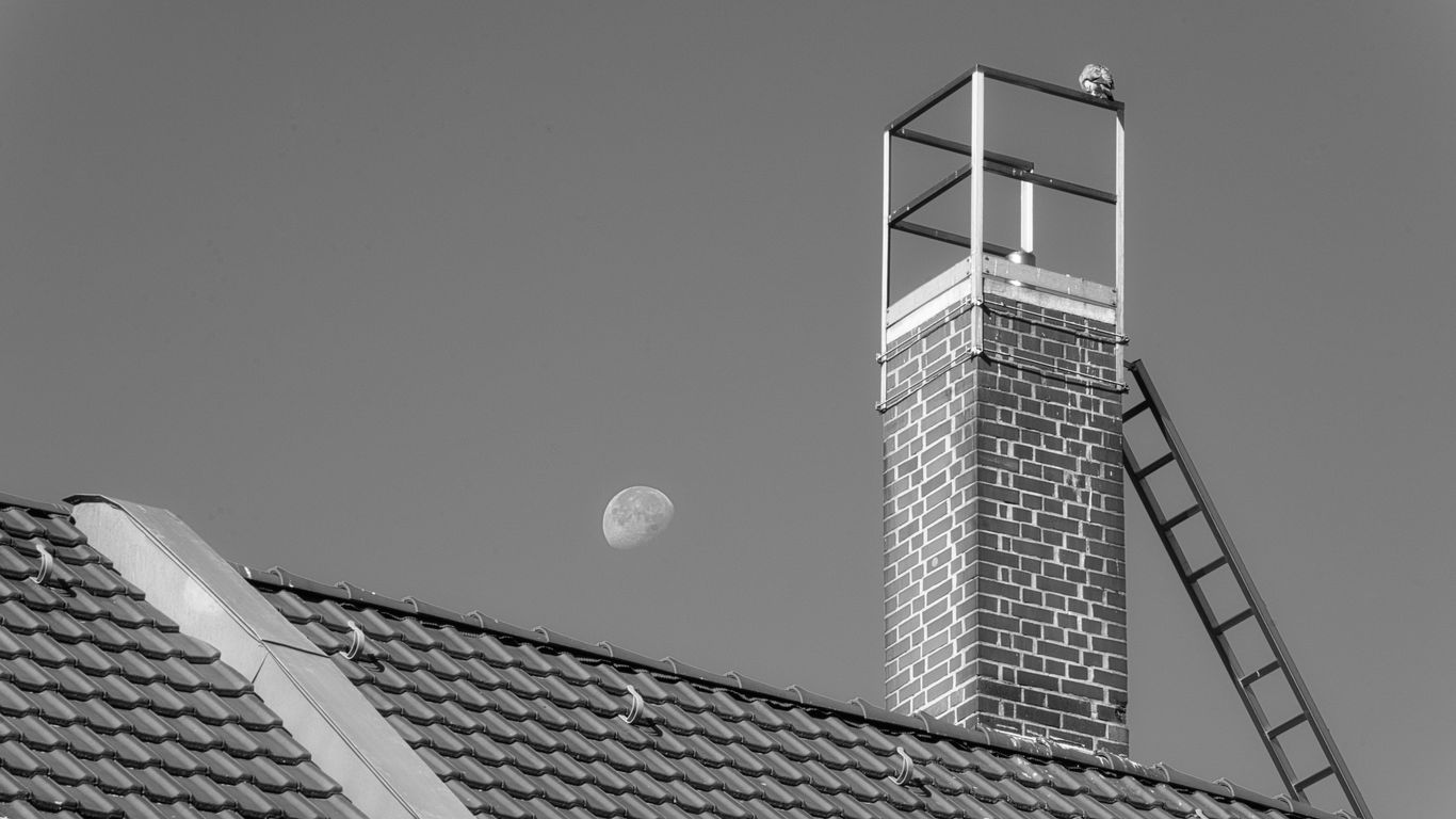 a black and white photo of a building with a clock tower